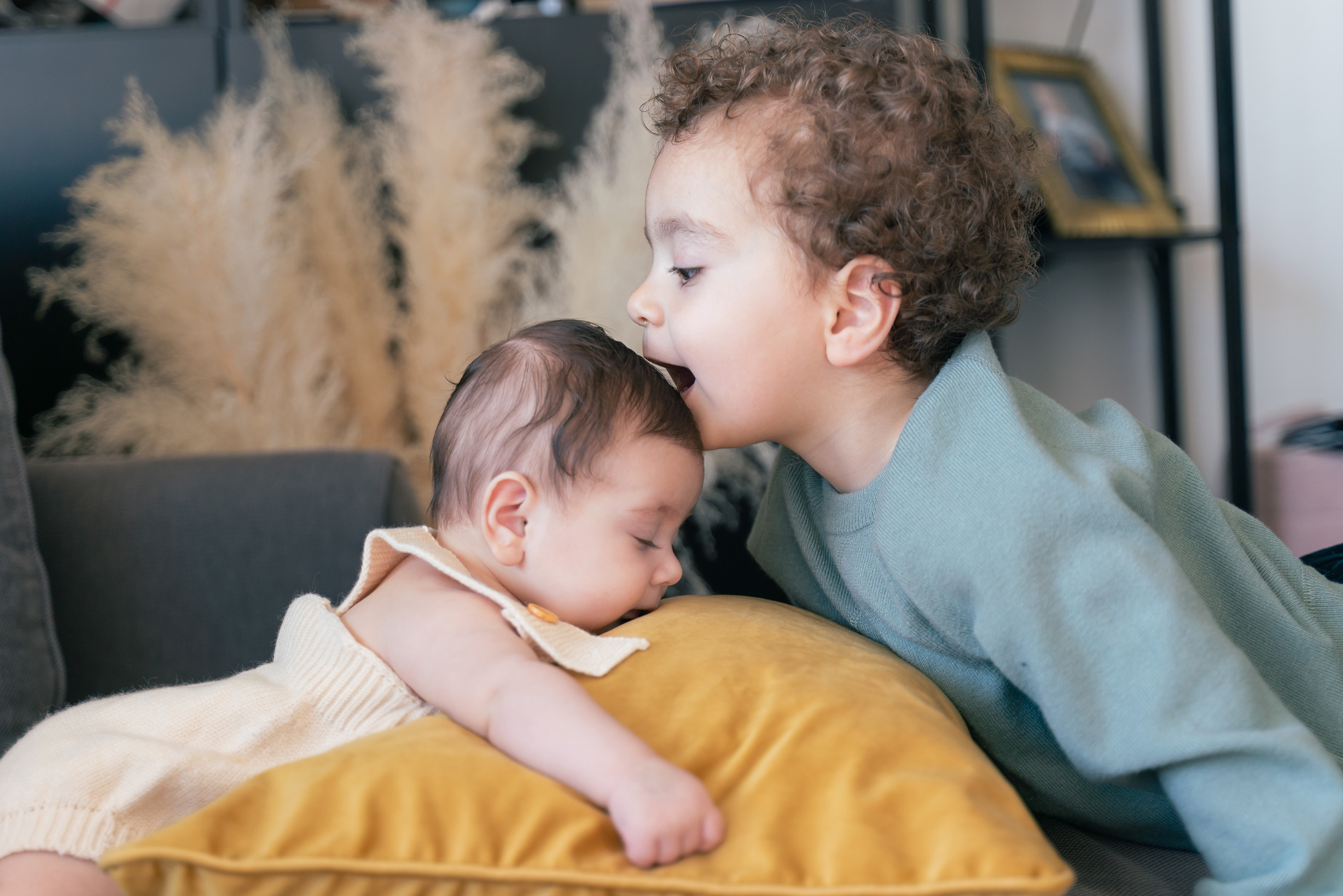 A toddler and his baby sister in home photo session
